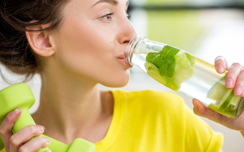Healthy woman drinking water.